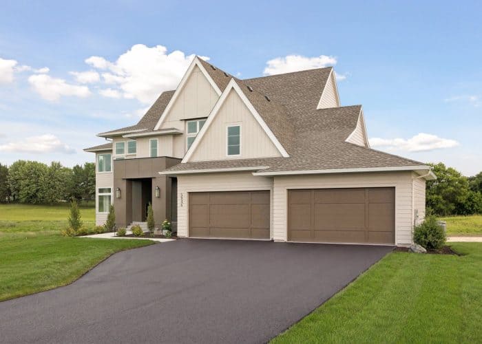 Modern two-story home with three-car garage and curved driveway