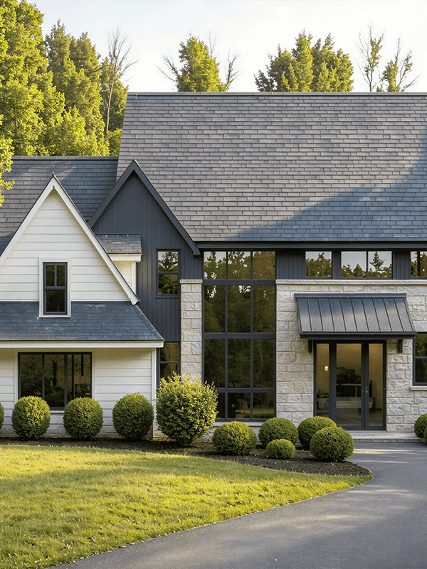Modern two-story house with landscaped lawn and curved driveway