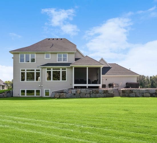 Rear exterior of a two-story custom home with screened porch