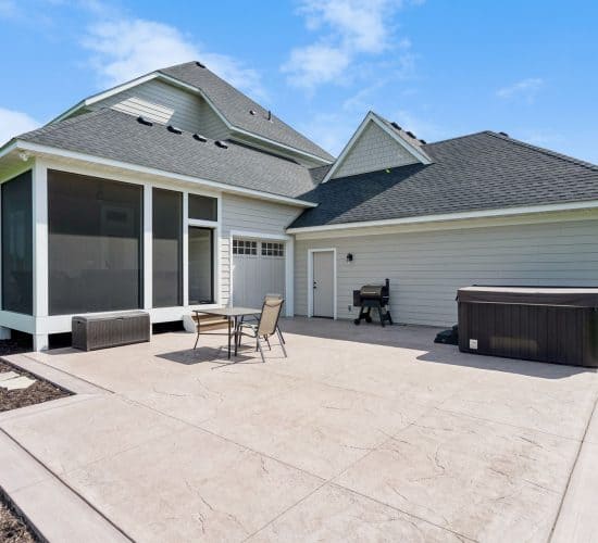 Backyard patio with screened porch, outdoor seating and hot tub