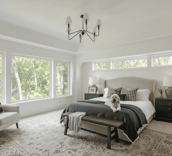 Dog resting on bed in bright modern bedroom