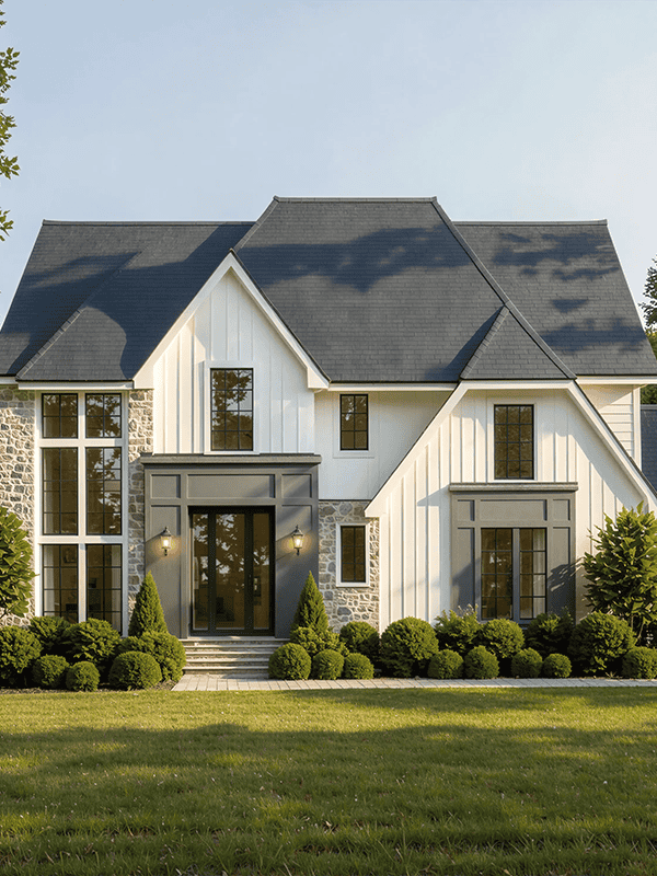 Modern white farmhouse with stone facade and attached garage