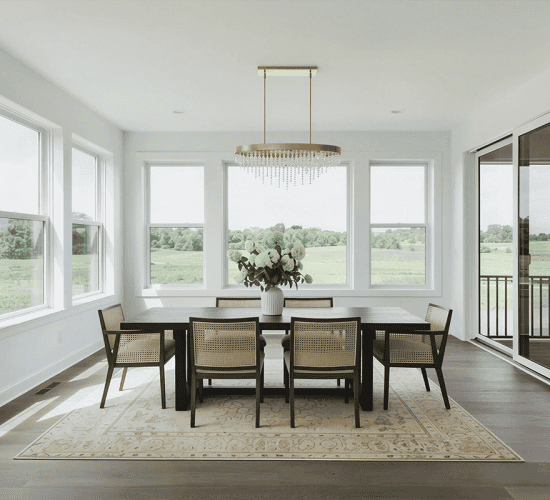 Bright dining room with large windows and modern chandelier