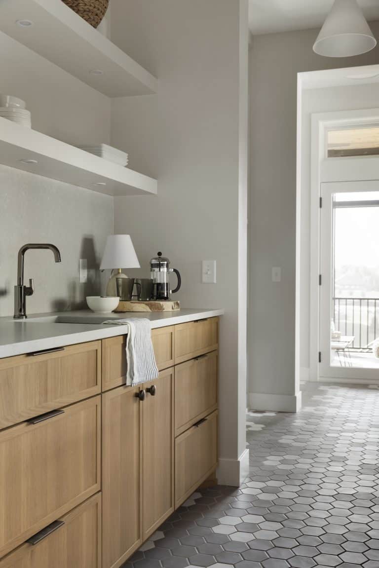 Modern kitchen with wood cabinets, open shelves, and hexagon tile floor
