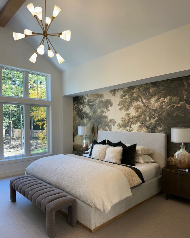Elegant bedroom with large window, modern chandelier, and nature mural.